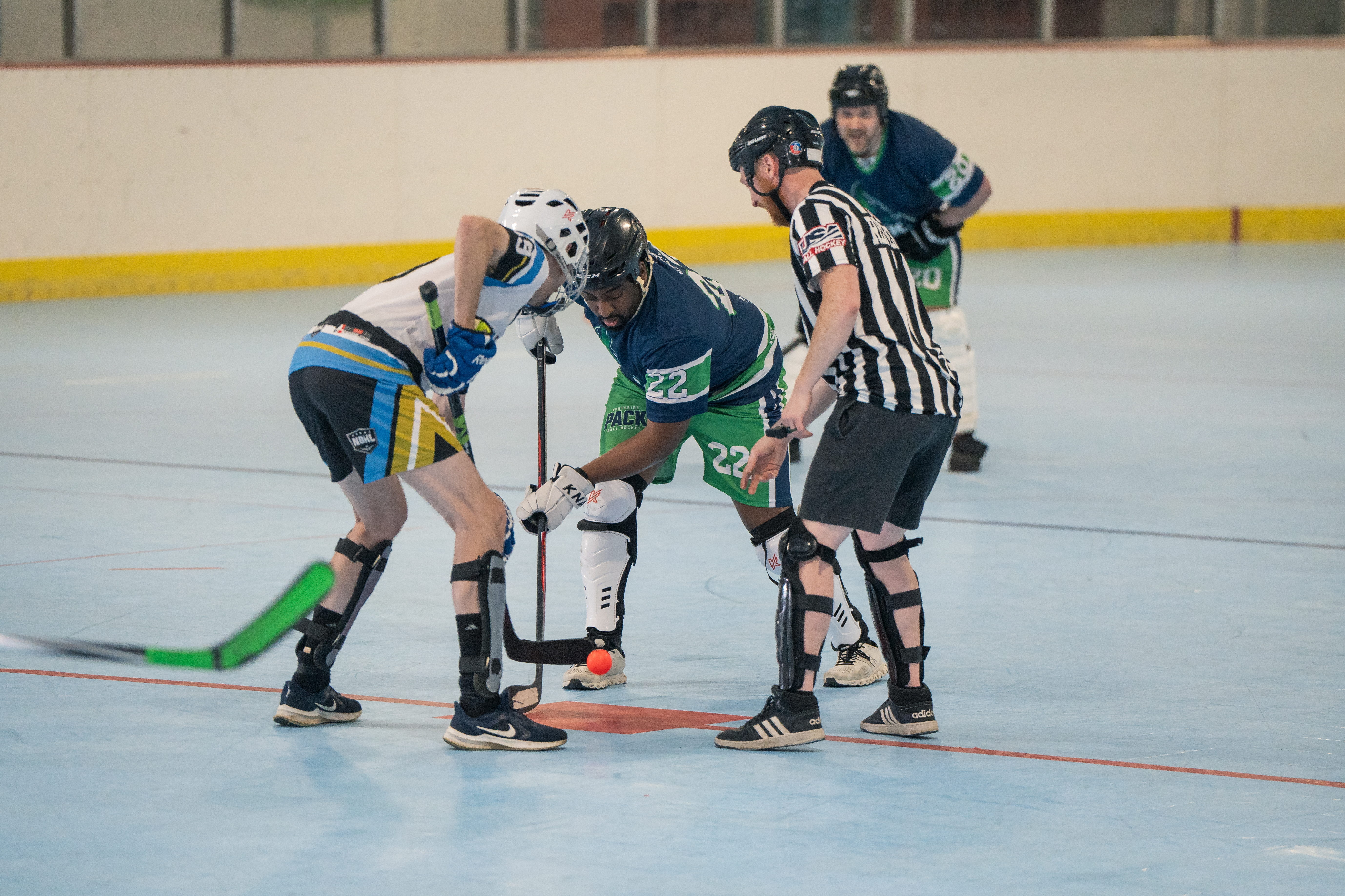 Ball hockey players competing on the rink