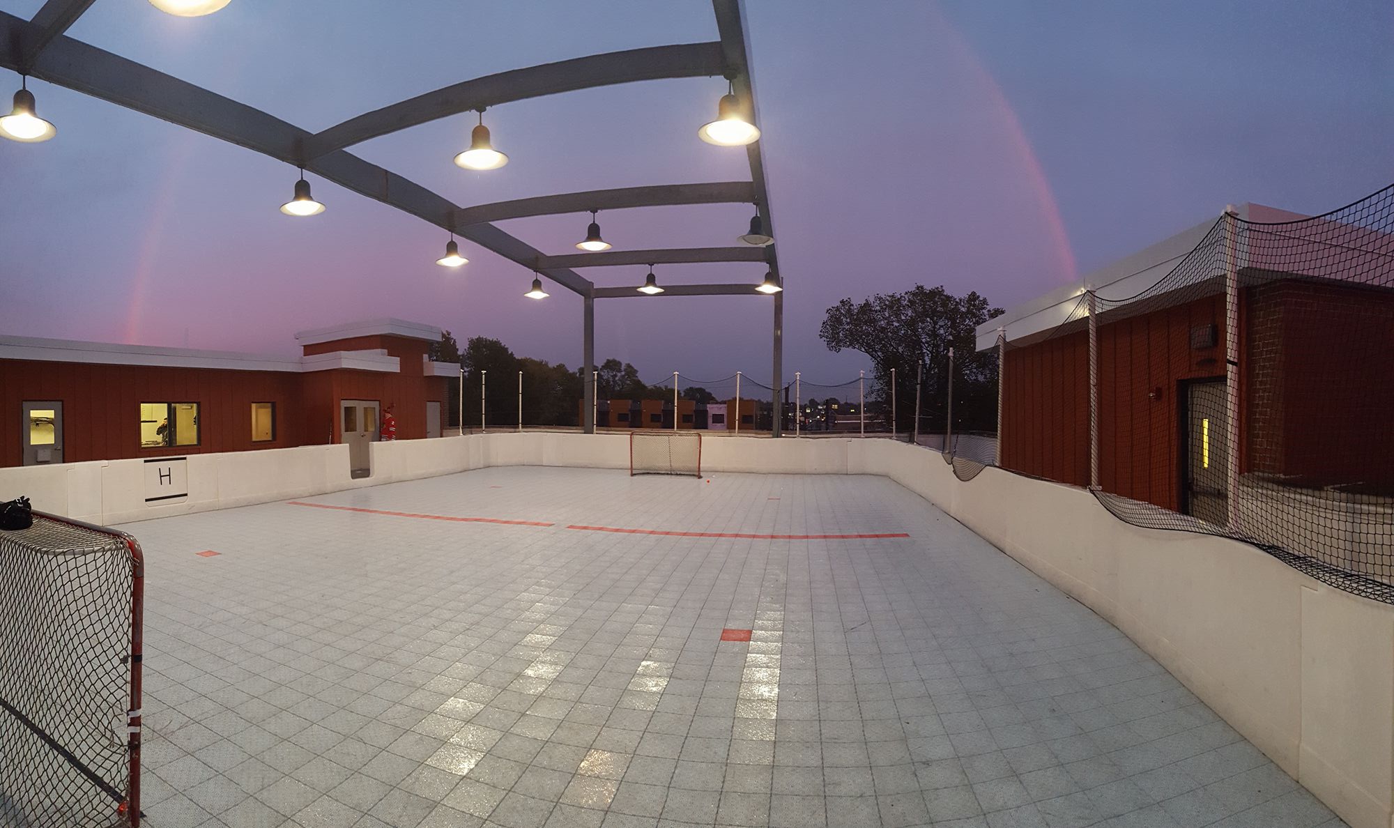 Rooftop ball hockey players competing outdoors